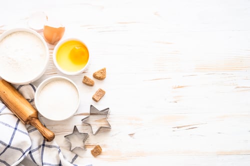 Preview: Baking ingredients at white wooden table.