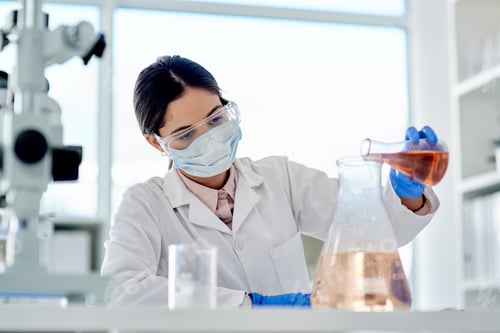 Preview: I hope this reacts as I expect it to. Shot of a young scientist doing an experiment in a lab.