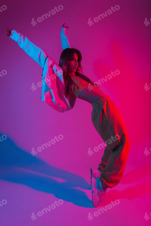 Preview: Modern fashionable model young woman in stylish clothes in trendy gym shoes dancing