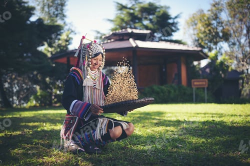 Preview: Akha in the north of Thailand enjoying coffee from shell by bamboo basket with traditional cloth.