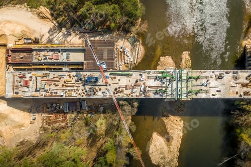 Preview: Flying above big construction of a bridge with high crane