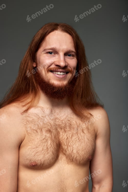 Preview: Close-up studio portrait of a young red-haired naked man with long straight hair, mustache and beard