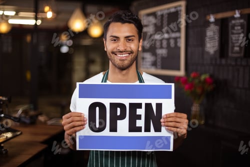 Preview: Smiling Barista Holding Open Sign In The Bar