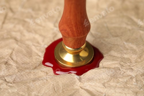 Preview: Sealing crumpled paper with wax stamp, closeup