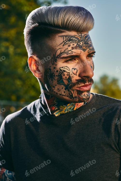 Preview: Portrait of tattooed young man outdoors