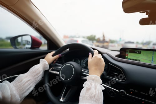 Preview: Woman driving car. girl feeling happy to drive holding steering wheel and looking on road
