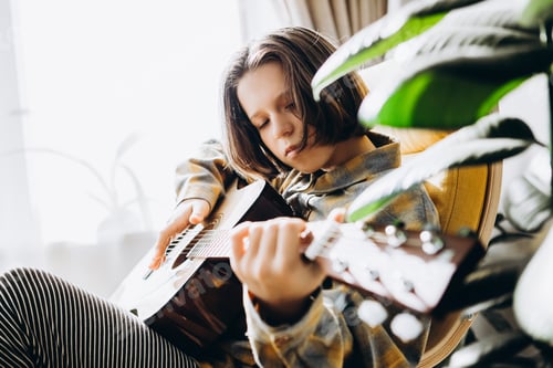 Preview: teenage girl learning to play guitar
