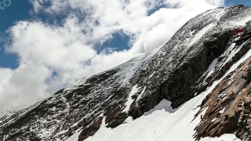 Preview: Beautiful scenery of a mountainous landscape covered with snow under a cloudy sky