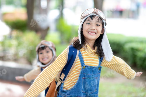Preview: A cute little girl dressed in a cap and glasses of a pilot. The child dreams of becoming a pilot.