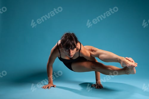 Preview: Active athletic woman standing in hands working at arm balance