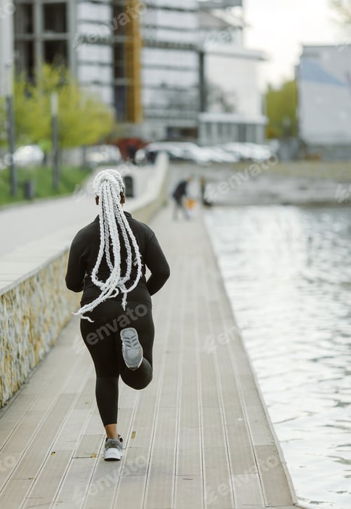 Preview: Afro-american plus size woman jogging outdoor