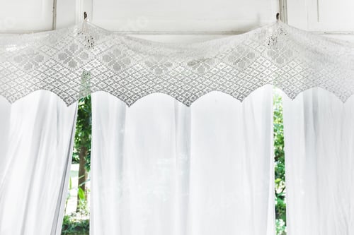 Preview: White curtains with patterns on veranda of residential wooden house. Balcony in rustic style