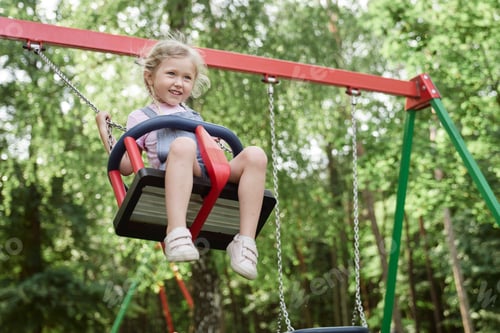 Preview: Caucasian cute little girl have fun at the swing set