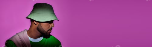 Preview: young man in panama with earring posing in profile on purple backdrop, fashion concept, banner