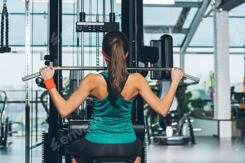 Preview: sporty woman working out on training apparatus