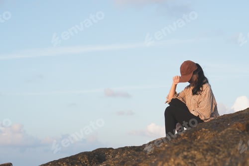 Preview: lonely woman sitting on the beach