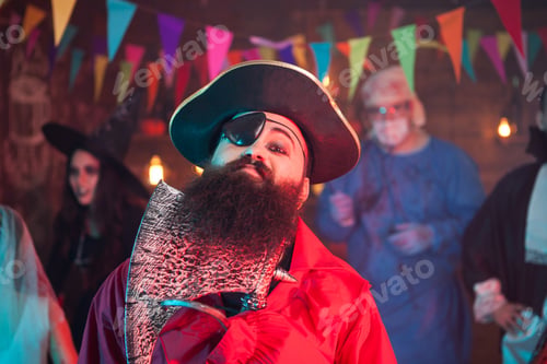 Preview: Scary man dressed up like a party playing with his beard and celebrating halloween