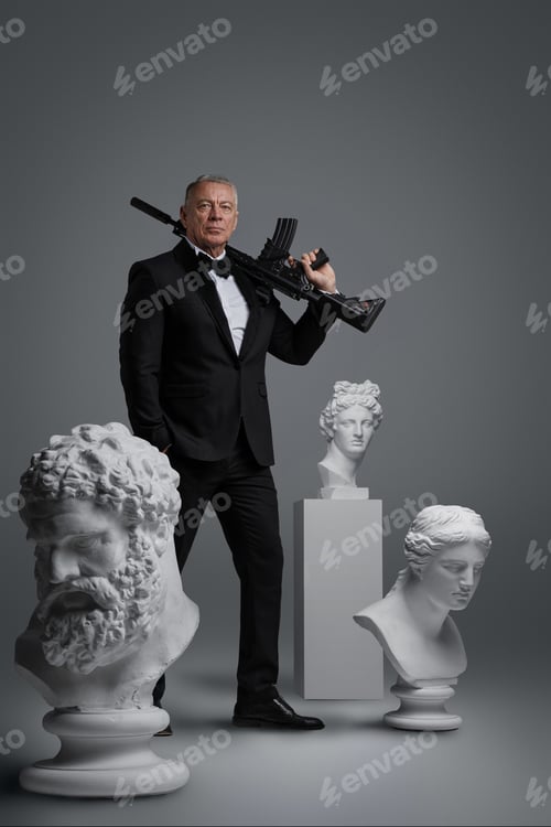 Preview: Stylish older man in expensive suit holding gun surrounded by ancient sculptures