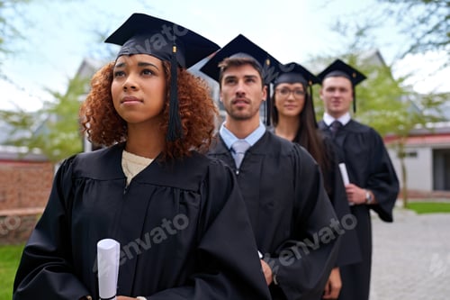 Preview: Shot of graduating university students standing in a row looking up