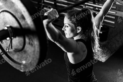 Preview: Cross training. Female athlete lifting heavy barbells