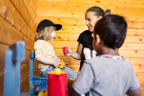 Preview: Young Child Giving Drink to Another Child