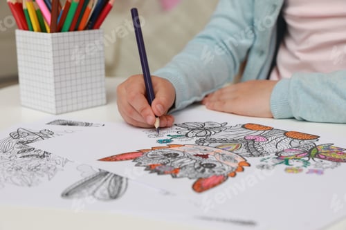 Preview: Little girl coloring antistress page at table, closeup