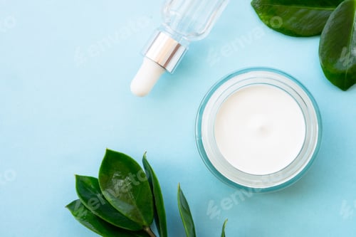 Visualização: Cosmético natural, frasco de creme com folhas verdes em azul.