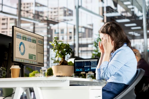 Preview: Unwell tired employee deals with a severe headache at the workstation