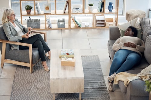 Preview: Woman, therapy patient and relax on sofa, talking or advice in mental health, support and psycholog