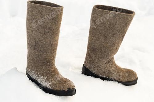 Preview: close up of felt boots standing in the snow