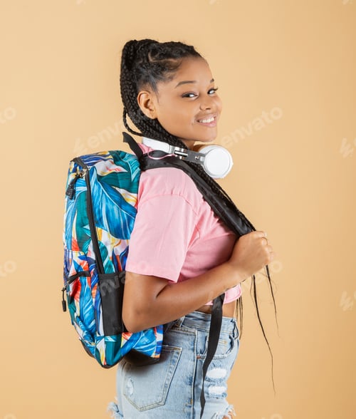 Preview: pretty afro american girl, with backpack and headphones smiling