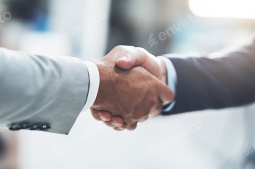 Preview: Cropped shot of two unrecognizable businessmen shaking hands after making a deal in the office