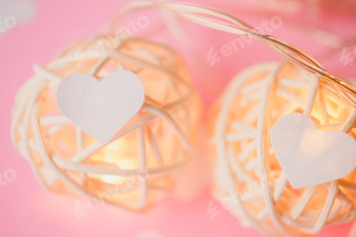Preview: Little White Hearts, Light And Ball Decoration On Pink Paper Background For Valentines Day Concept