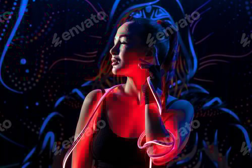 Preview: A young woman in fashionable youth club clothes in neon light. neon lights. Nightlife