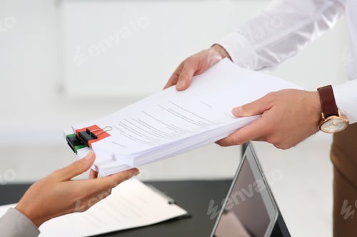 Preview: Woman giving documents to colleague in office, closeup