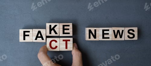 Preview: Business man hand holding wooden cube with flip block FAKE to FACT News
