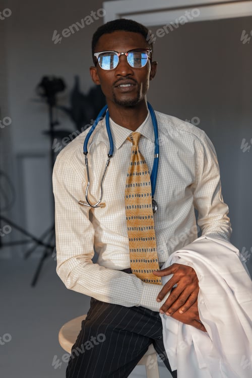 Preview: Handsome Guy Doctor In White Lab Coat With Stethoscope On White Background