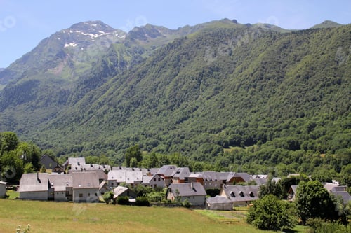 Preview: Village in a lush valley with mountain backdrop