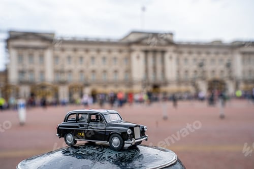 Preview: Closeup shot of a traditional black cab driving through the most famous landmarks in London