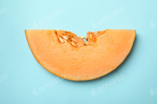 Preview: Melon slice on blue background, close up