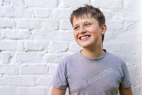 Preview: sweetly smiling teenager turned to side. boy turned to right with smile on face
