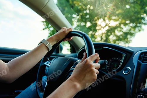Preview: Inside view of woman driving car on countryside road