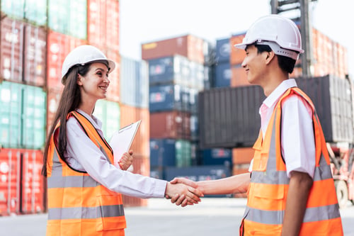 Preview: Caucasian business woman and Asian business man work in terminal port.
