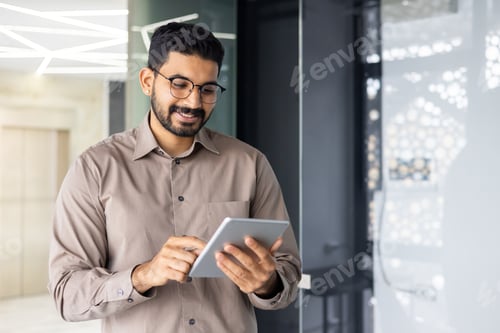 Preview: Professional businessman using tablet in modern office environment