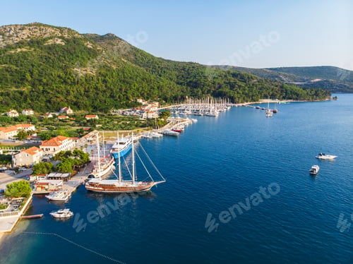 Preview: Scenic aerial view many yachts boats moored at Croatian bay harbor shore blue turquoise clear water