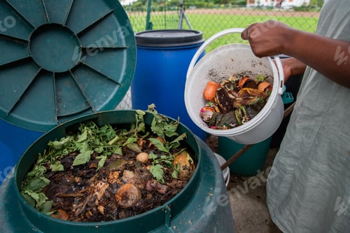 Preview: A woman empties a bucket of organic waste into a compost bin