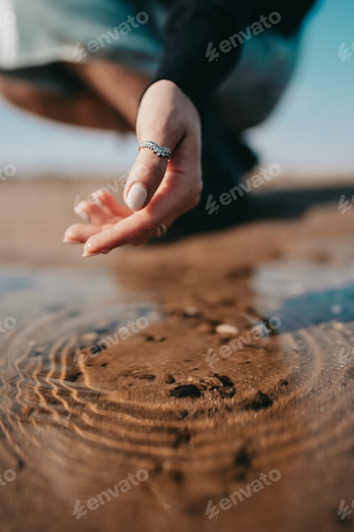 Preview: Woman’s hands under water of river surface