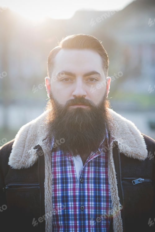 Preview: Young bearded man, building in background