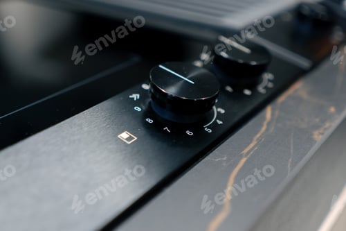 Preview: close-up of a professional kitchen with a metal part of the oven with temperature and time switches