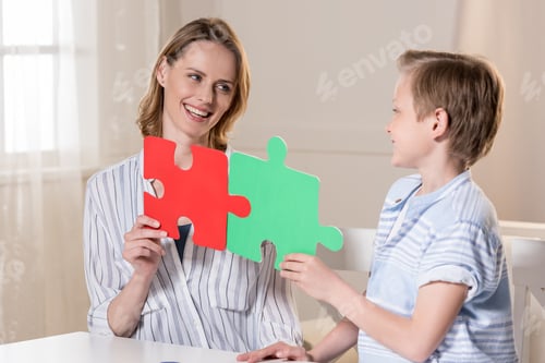 Preview: Mother with son holding puzzle pieces